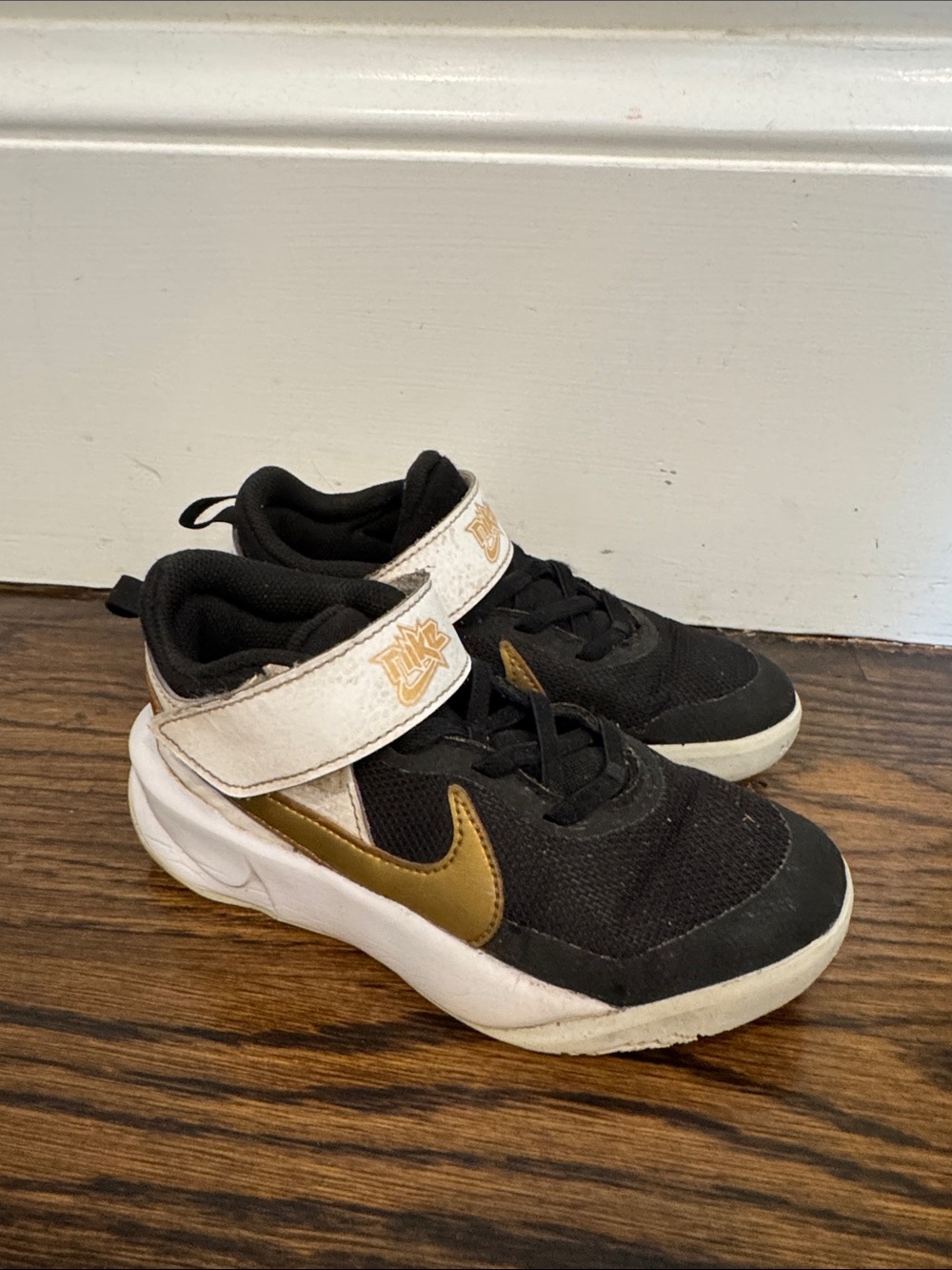 Kid Nike black and gold sneakers